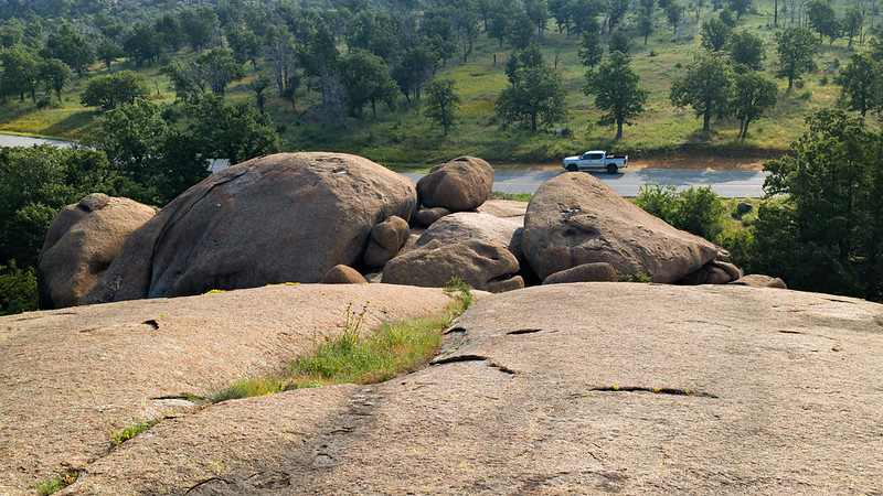 Truck Beside Giant Granite Boulders Silver truck parked on Indiahoma Road beneath towering granite boulders in the Wichita Mountains Wildlife Refuge.