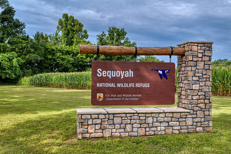Entrance Sign at Sequoyah National Wildlife Refuge Entrance sign for Sequoyah National Wildlife Refuge with cornfield and cloudy sky in Oklahoma