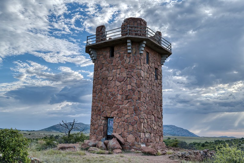 Stone Jed Johnson Tower overlooking Lake Jed Johnson Oklahoma under dramatic morning storm clouds.