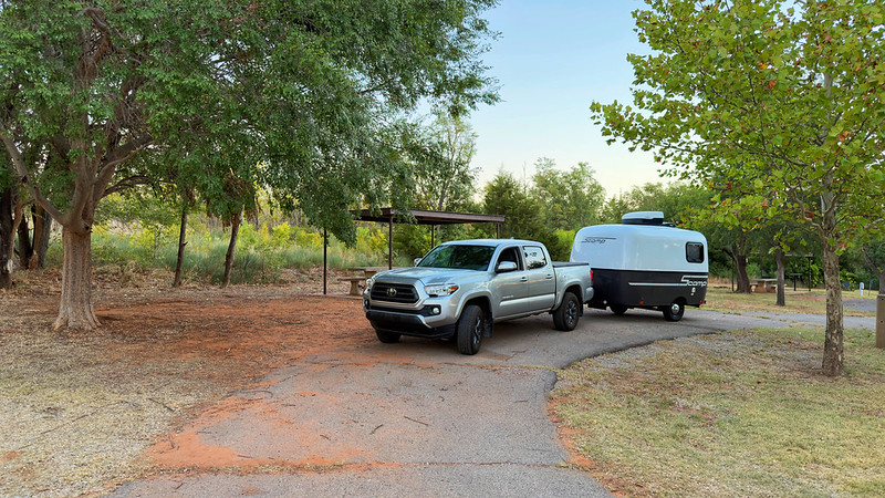 My truck and travel trailer at a tree-lined campsite at Fort Supply Lake in Oklahoma